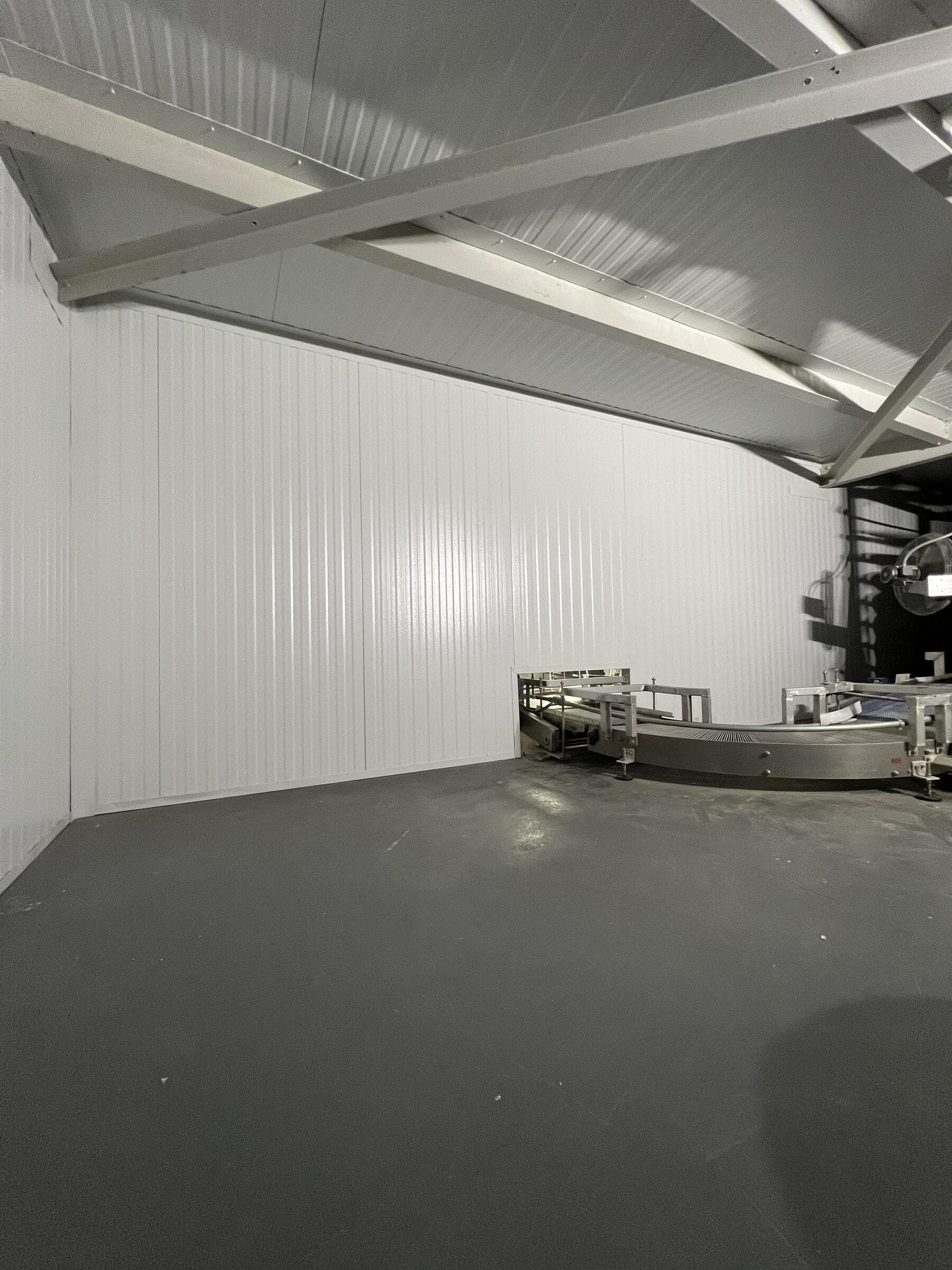 Interior insulated metal panel installation in a commercial facility